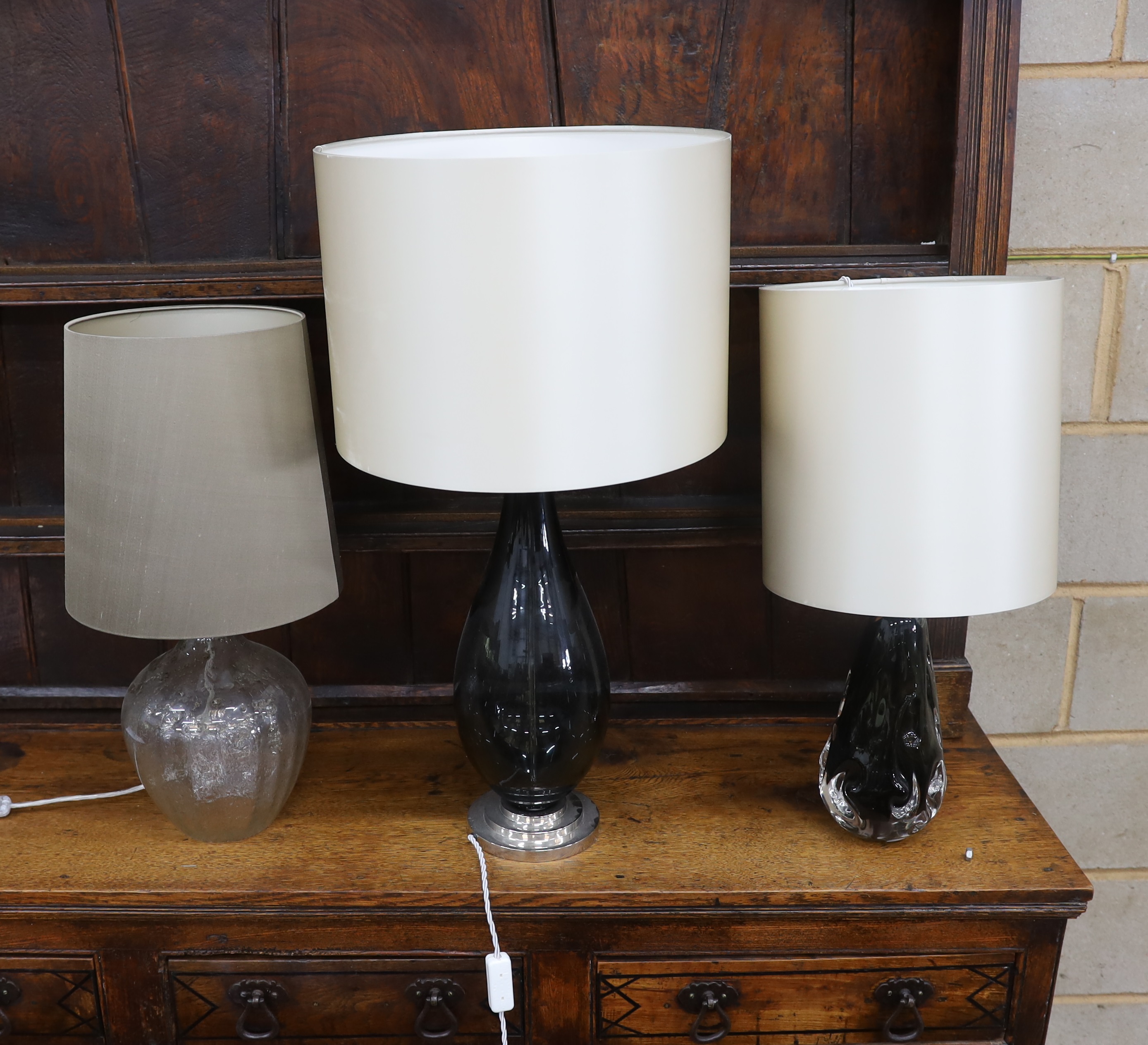 A contemporary Porta Romana baluster glass table lamp and shade, height 78cm together with two other contemporary glass table lamps